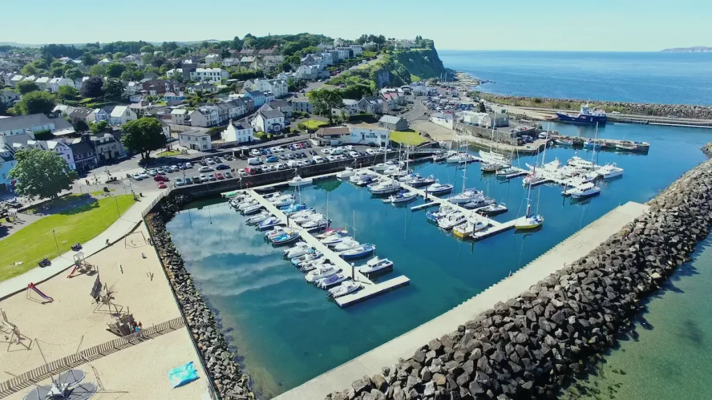 A view from the air of ballycastle harbour and marina looking back up harbour hill